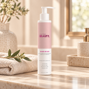 Bare Bliss | Hydrating Moroccan Argan Oil Shampoo | 10 oz on a cream bathroom vanity with a folded towel and greenery