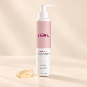 Bare Bliss | Hydrating Moroccan Argan Oil Shampoo | 10 oz with a formula texture swatch on a cream surface