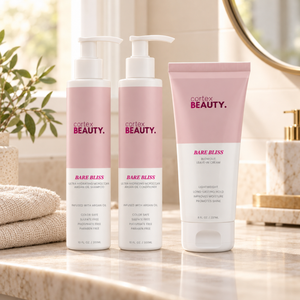 Blowout Perfect | Shampoo, Conditioner & Blowout Leave-In Cream Set on a cream bathroom vanity with a folded towel and greenery